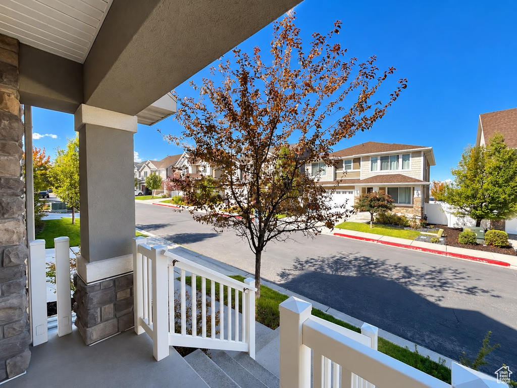 Covered entryway with stone veneer and stucco columns