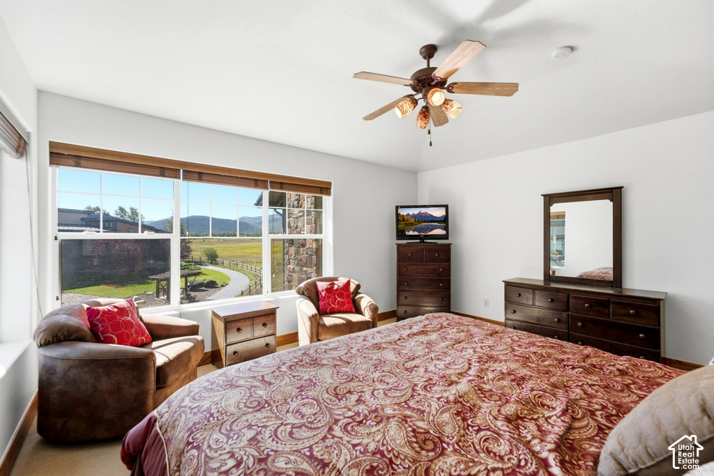 Expansive windows showcasing a distant mountain range and a winding paved path