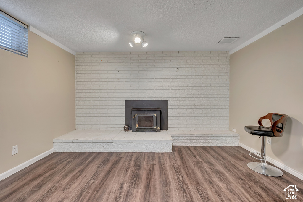 Integrated wood-burning stove with a white brick surround and hearth, wood-finish flooring, and recessed window