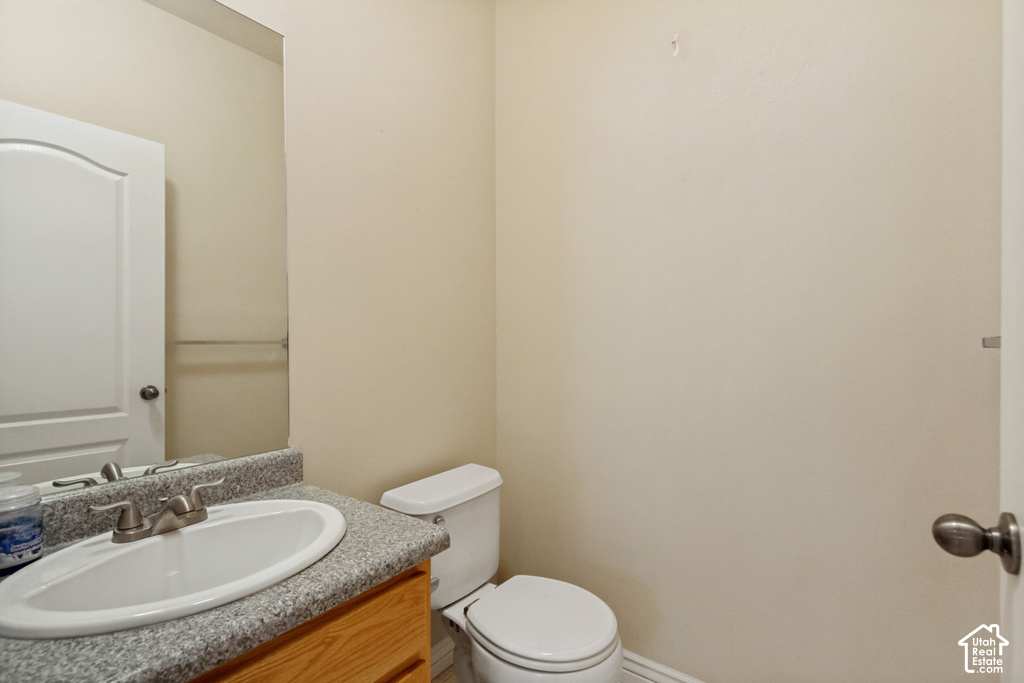 Vanity with a speckled countertop, undermount sink, and brushed nickel faucet