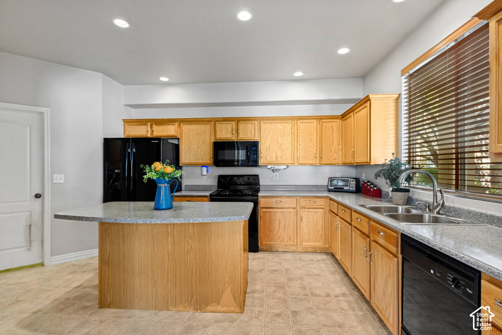 Kitchen featuring wood cabinetry, light-toned countertops, tile flooring, recessed lighting, and a double basin sink