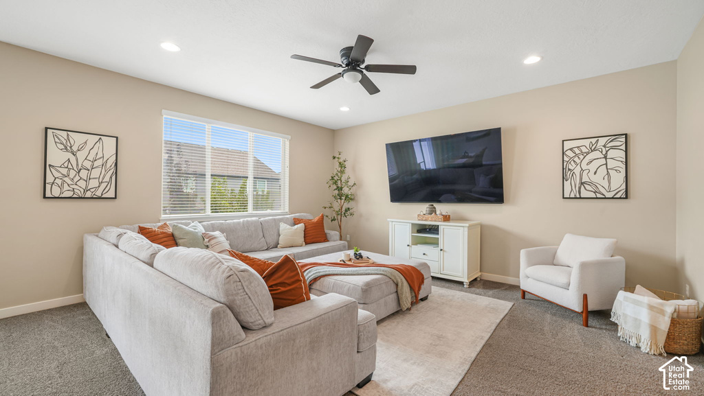 Recessed lighting, ceiling fan, carpeted flooring, wall-mounted television, and a built-in media console