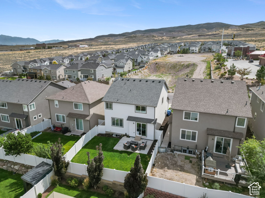 Expansive backyard featuring a manicured lawn, a concrete patio, and a privacy fence