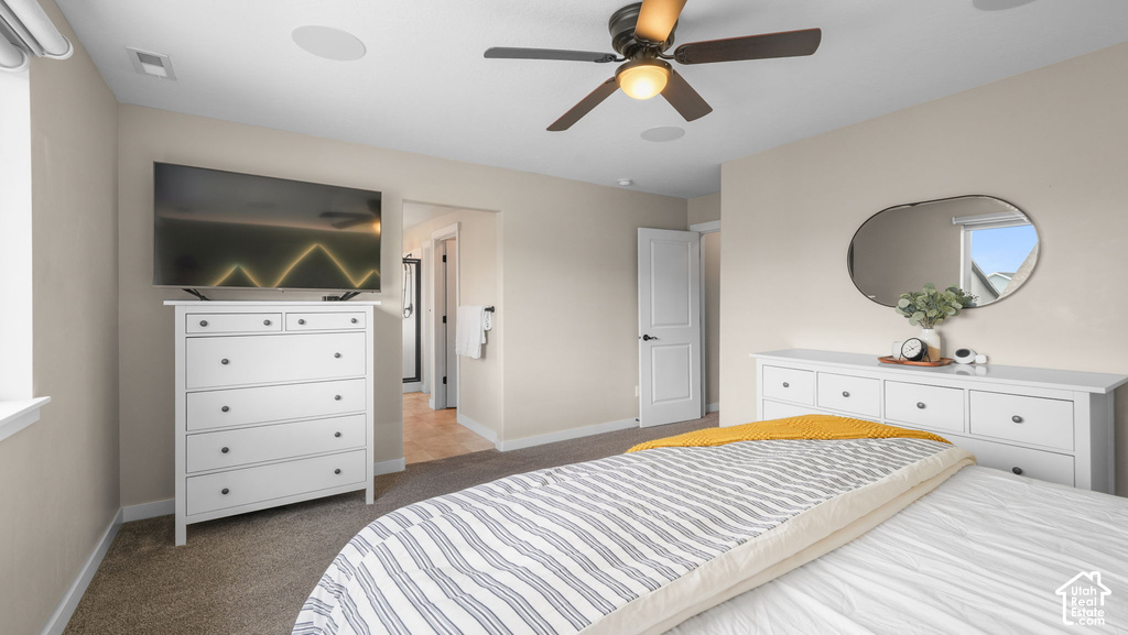 Carpeted flooring, ceiling fan with integrated lighting, recessed ceiling speakers, white paneled door, and a window with white trim
