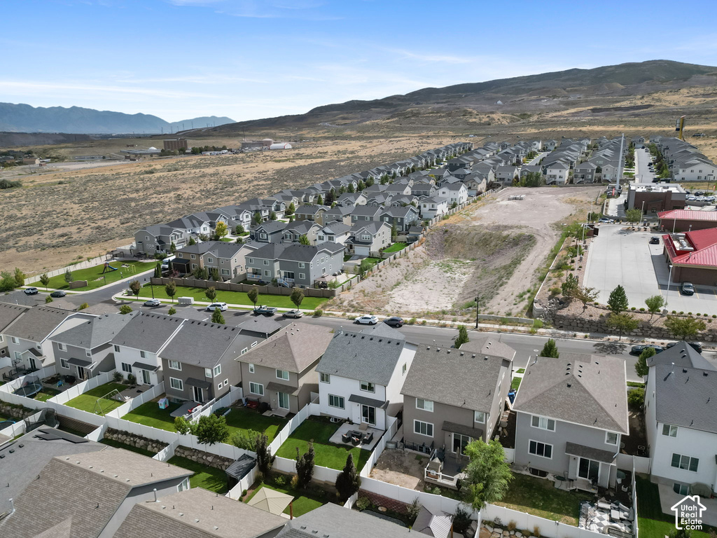 Residential neighborhood with detached homes, individual fenced yards, and street parking