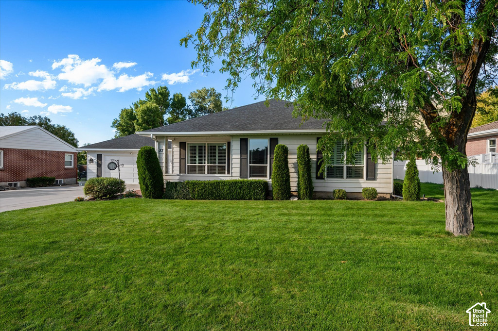 Exterior featuring horizontal siding, dark shutters, and a dark shingle roof