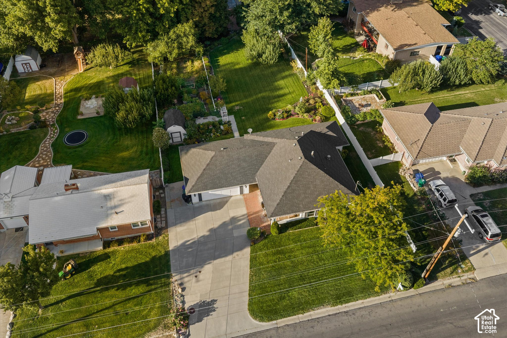 Expansive property featuring an attached garage, paved driveway, gabled roofline, and established landscaping