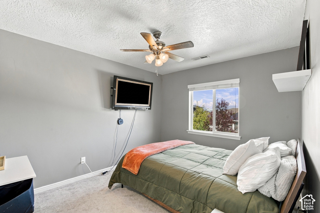 Recessed window with white trim, wall-mounted television, ceiling fan with integrated lighting, and a floating wall shelf