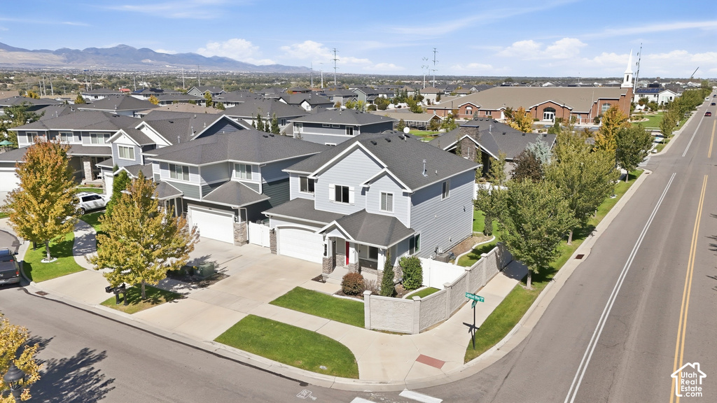 Corner lot residence with two-story design, attached garage, and stone accent facade