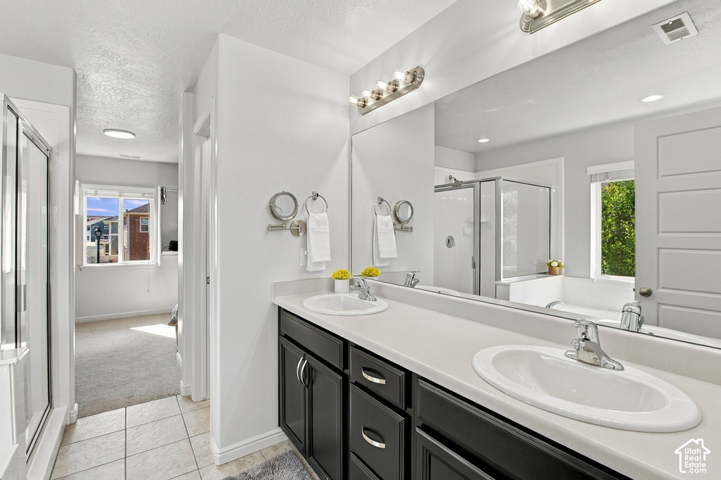 Dual vanity with undermount sinks, expansive countertop, and dark wood-finish cabinetry
