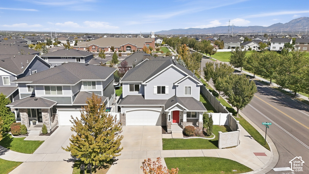 Two-story residence with a gray siding exterior and dark shingle roof
