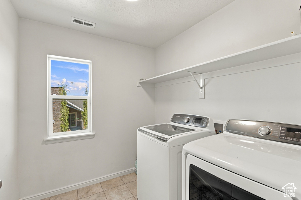 Window with white trim, ceramic tile flooring, and integrated wall shelving