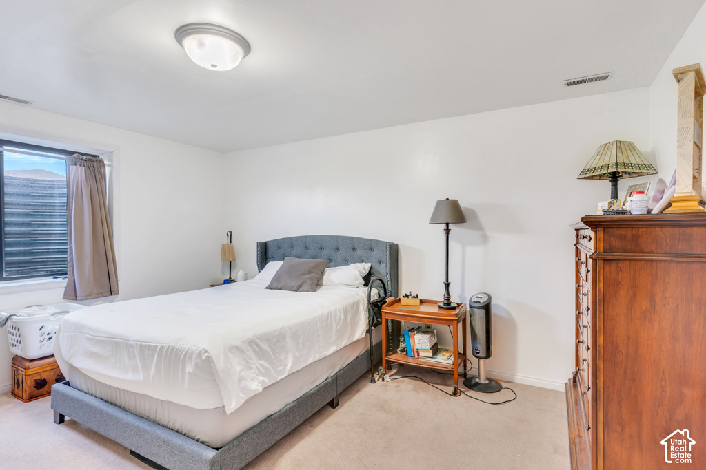 Recessed window with privacy blinds, neutral wall tones, flush-mount ceiling light, and carpeted flooring