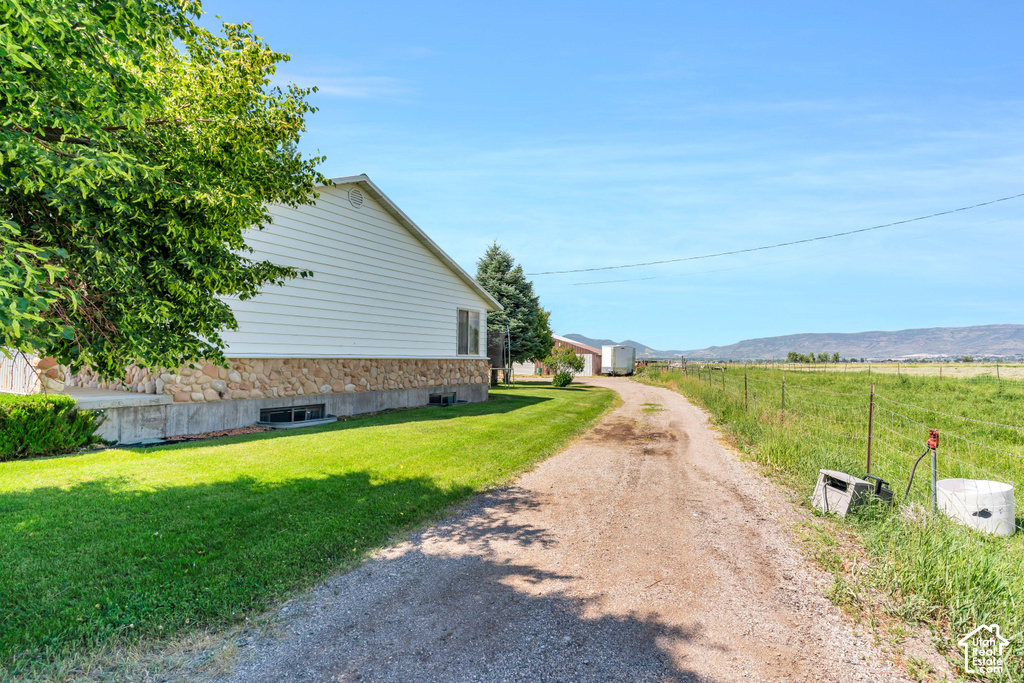 White siding exterior with a stone foundation
