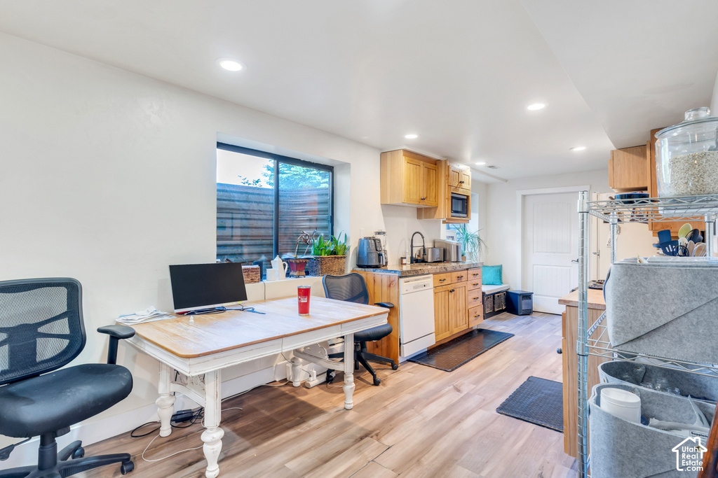 Kitchenette featuring wood-finish cabinetry, a built-in microwave, and a dishwasher