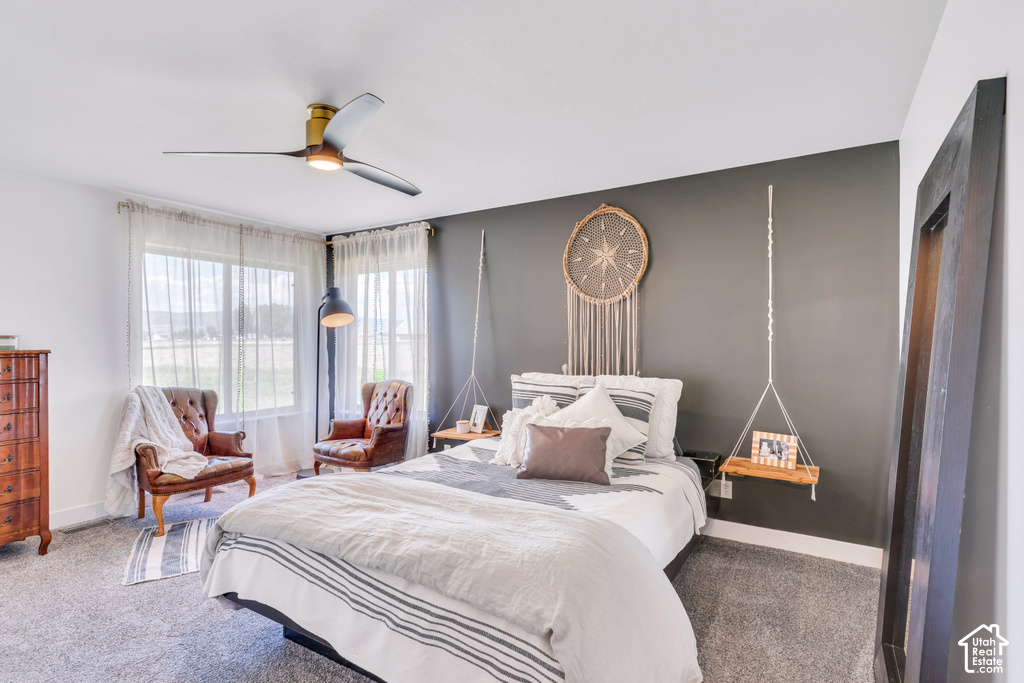 Dual paned windows, ceiling fan with integrated lighting, carpeted flooring, and a neutral color palette