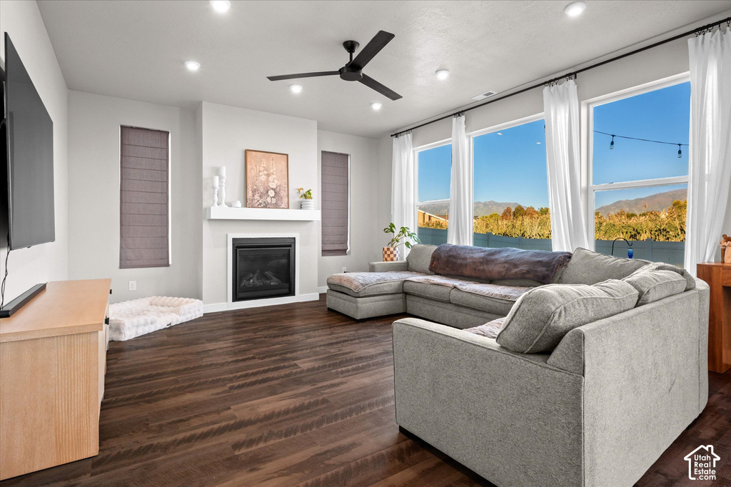 Warm wood-finish flooring complements the contemporary fireplace with a white mantel