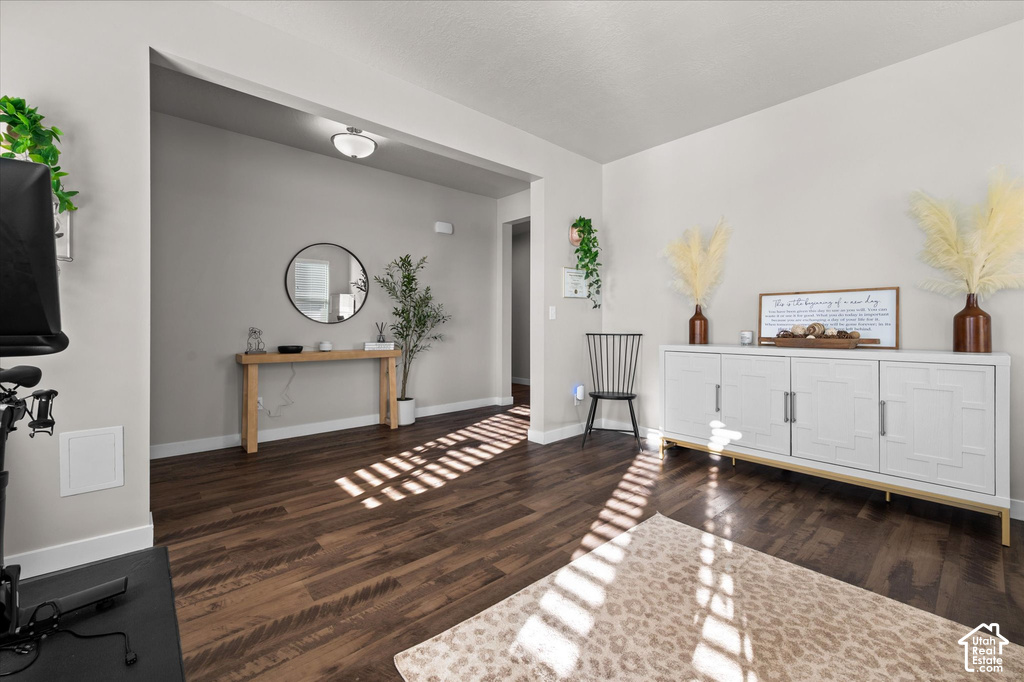 Wood-finish flooring throughout, light gray wall paint, and a built-in ceiling light fixture
