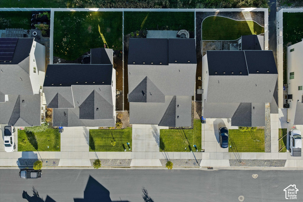 Aerial perspective highlighting residential properties, front landscaping, and concrete driveways