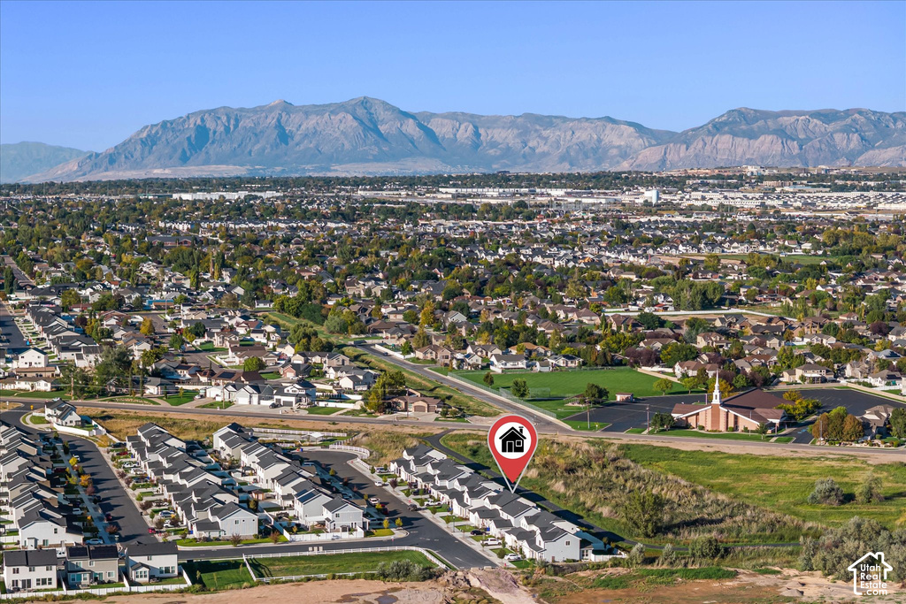 Expansive aerial perspective showcasing a residential neighborhood with distant mountain ranges