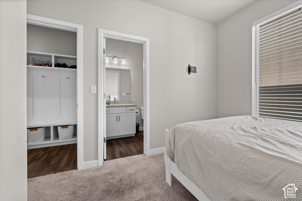 Built-in mudroom style shelving, wood-finish flooring, and a window with blinds