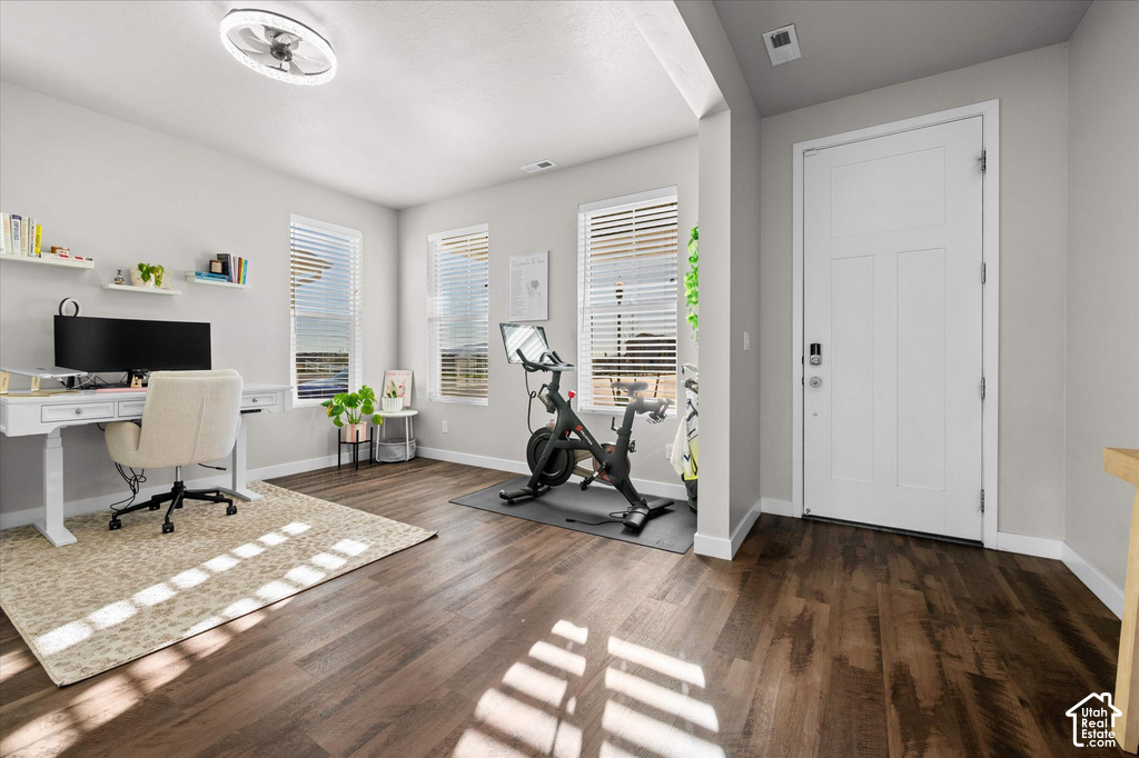 Entryway with wood-finish flooring, a white paneled door, and smart lock hardware