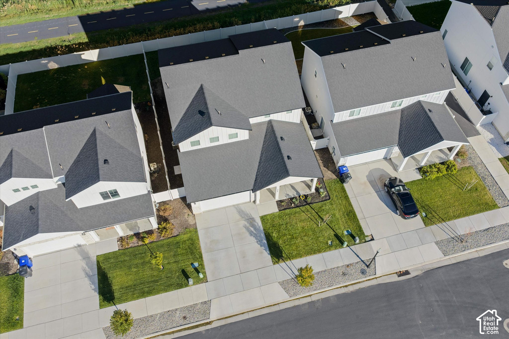 Aerial view of a modern residential community featuring multiple contemporary homes with clean-lined architecture, pitched rooflines, and neutral exterior finishes