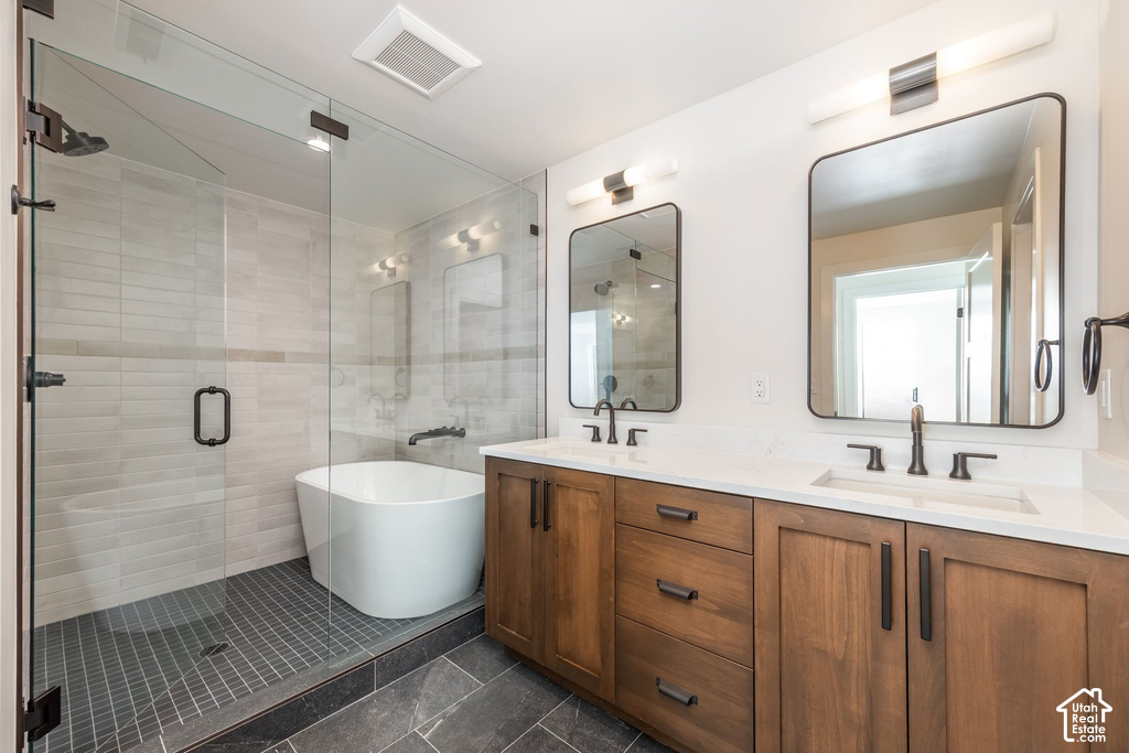 Dual vanity with quartz countertops, wood-finish cabinetry, and matte black fixtures