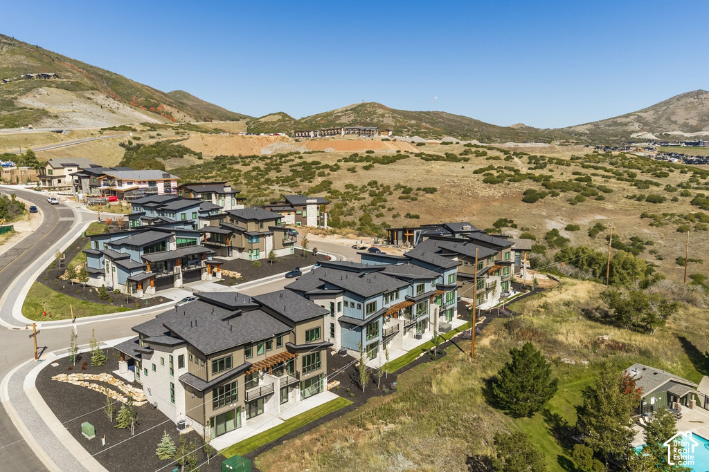Contemporary multi-story architecture with dark roofing and varied siding materials