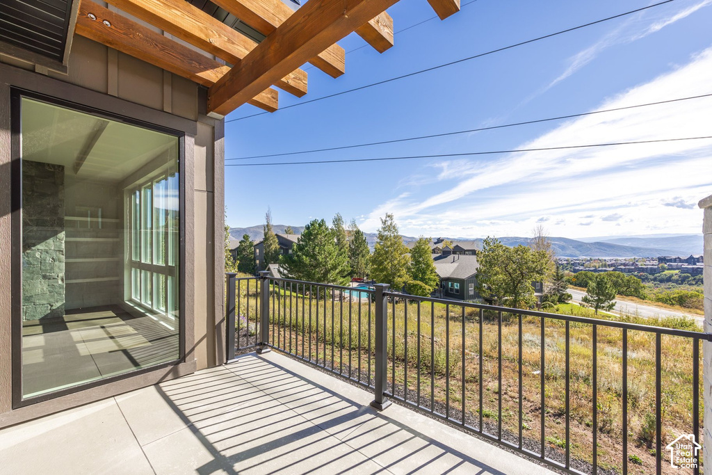 Private patio featuring a wood pergola and black metal railing
