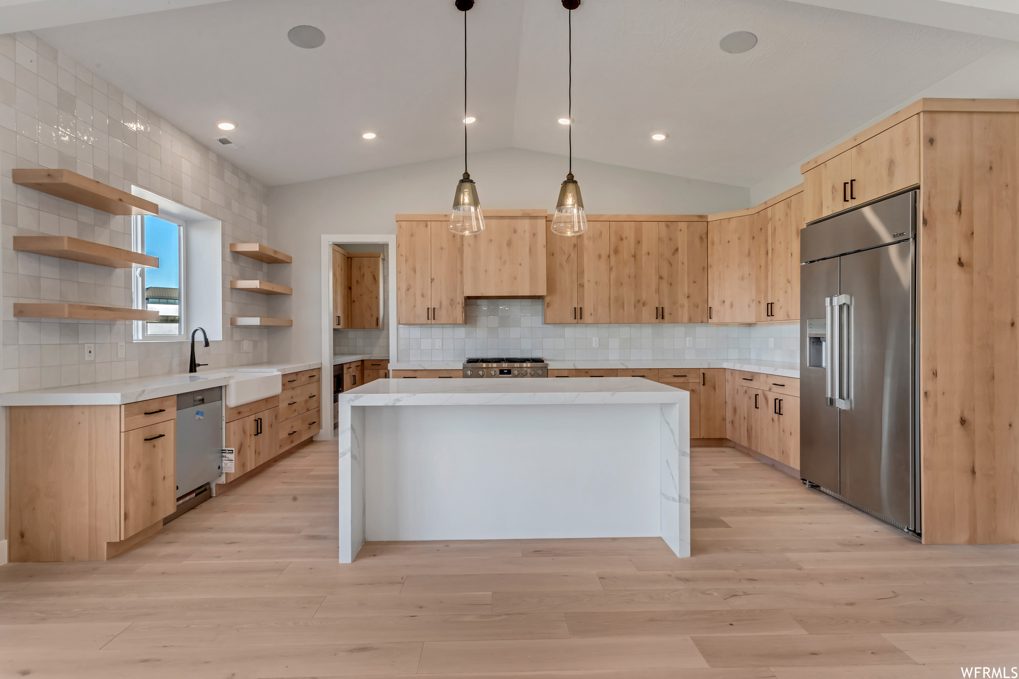 This owner chose to add waterfall countertops to the island and light maple cabinets