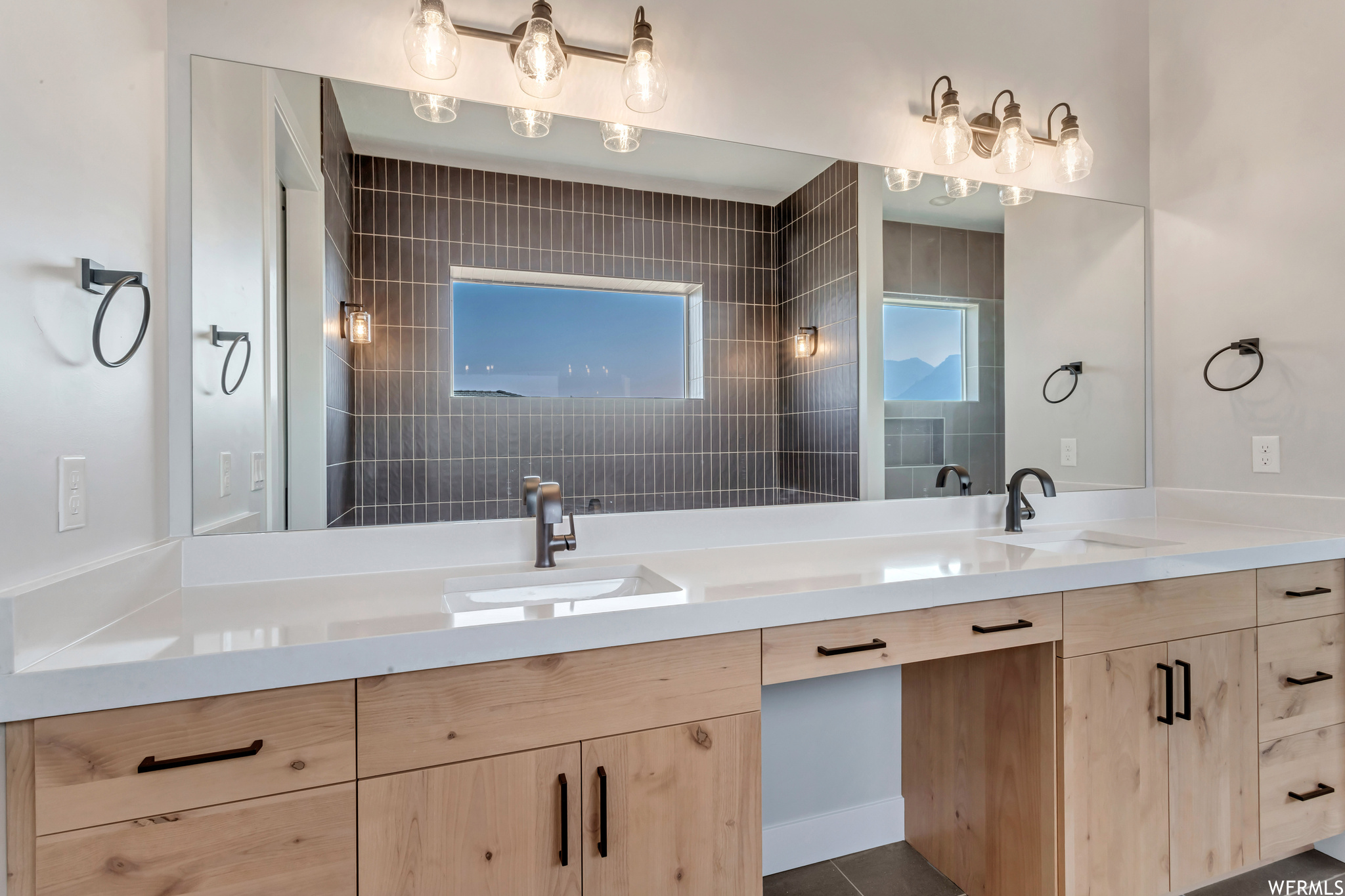 The primary suite bath includes double sinks, a vanity area, soaking tub, large shower and water closet.
