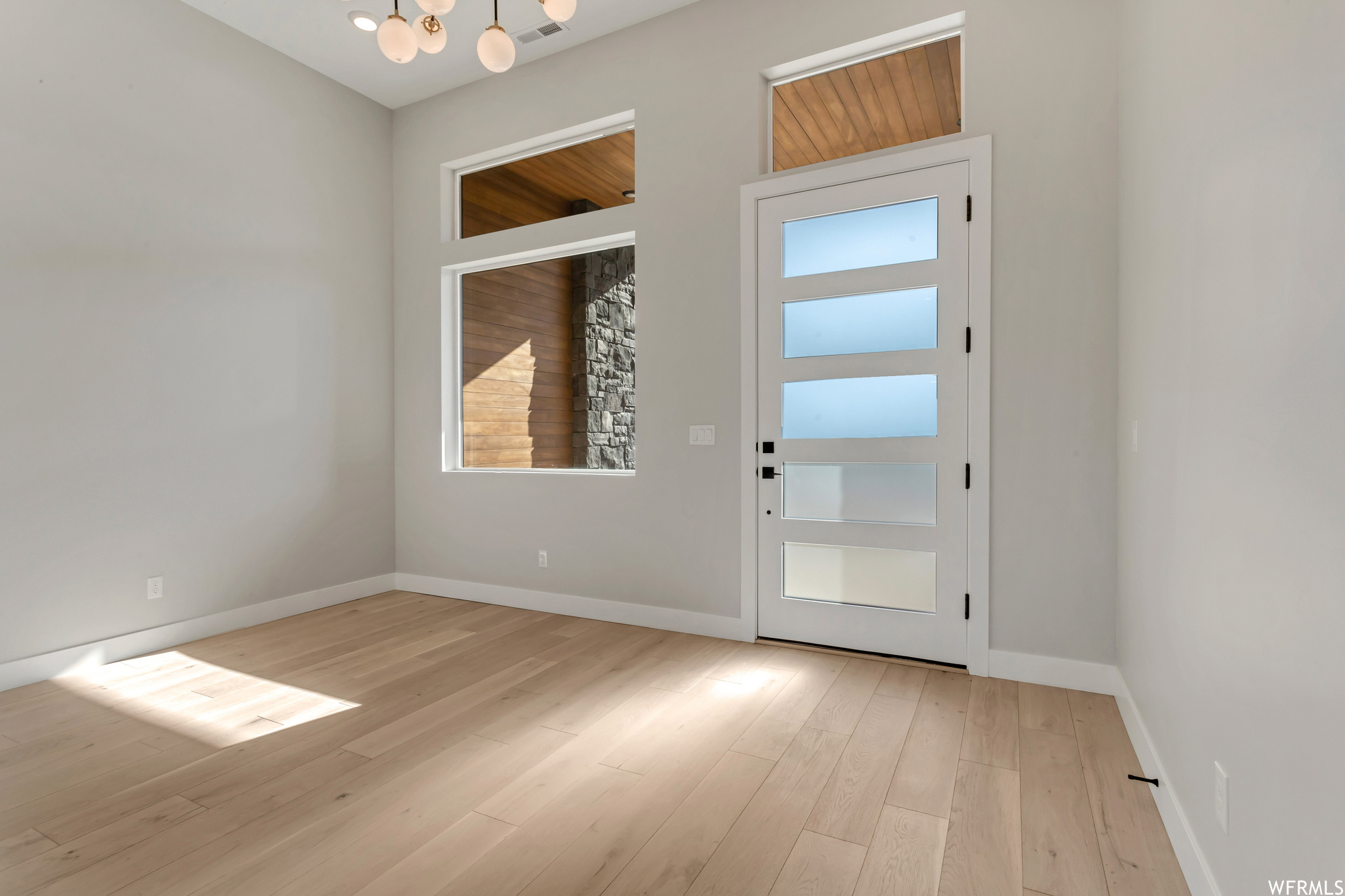 Front Room, all homes have a five panel glass front door, this room features a 12 foot ceiling