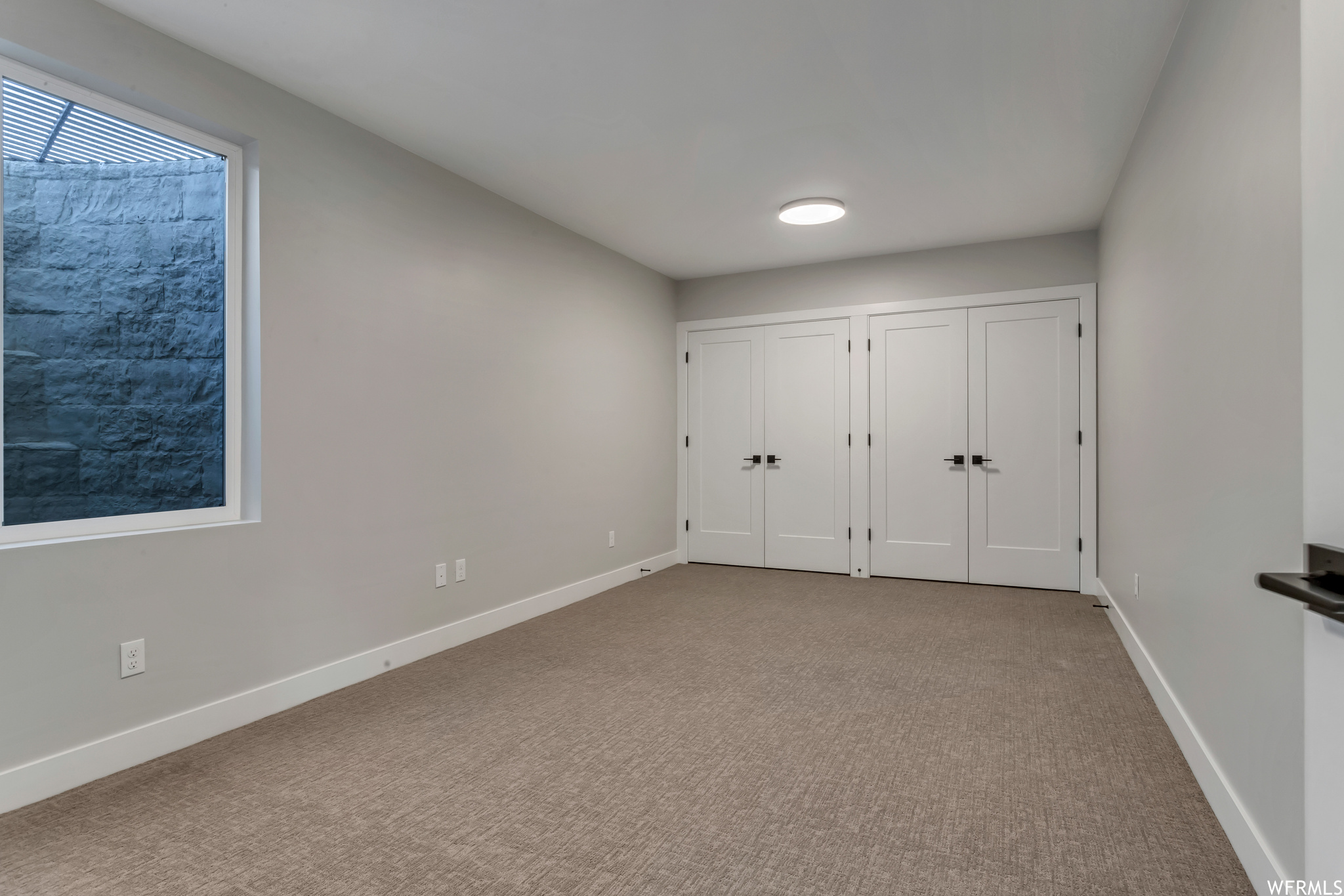 This owner added closets to this room under the third car garage for use as an additional bedroom or office