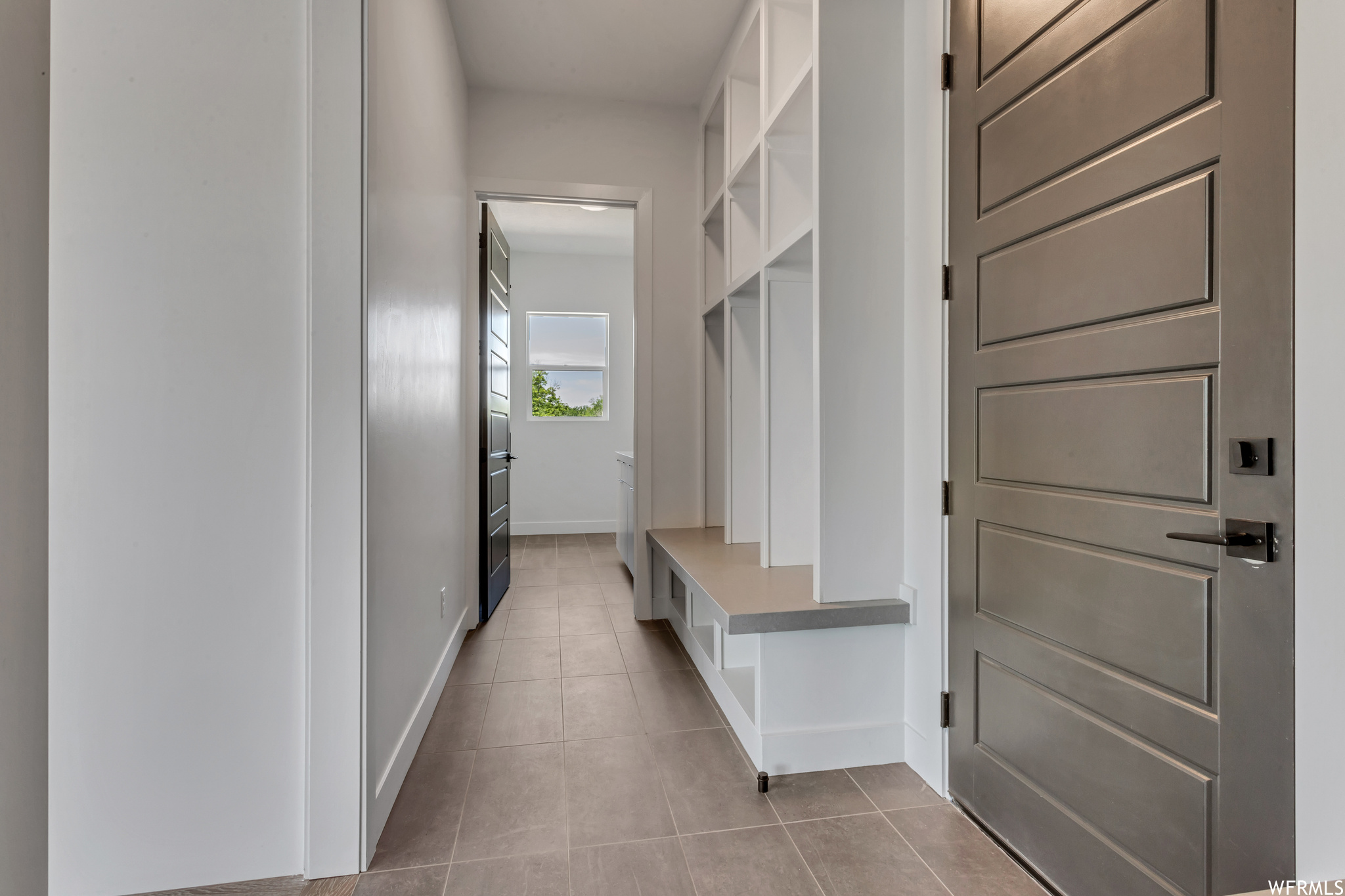 Hallway near garage entrance features a hard surface topped bench