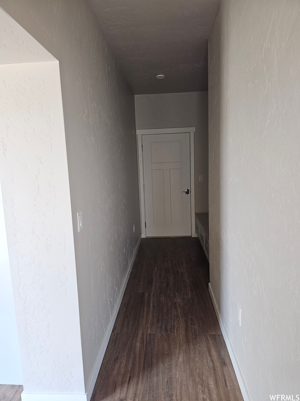 Hallway with dark parquet floors