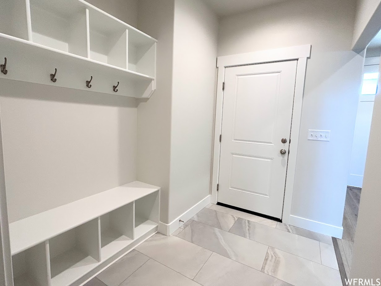 Spacious mud room with access to garage.