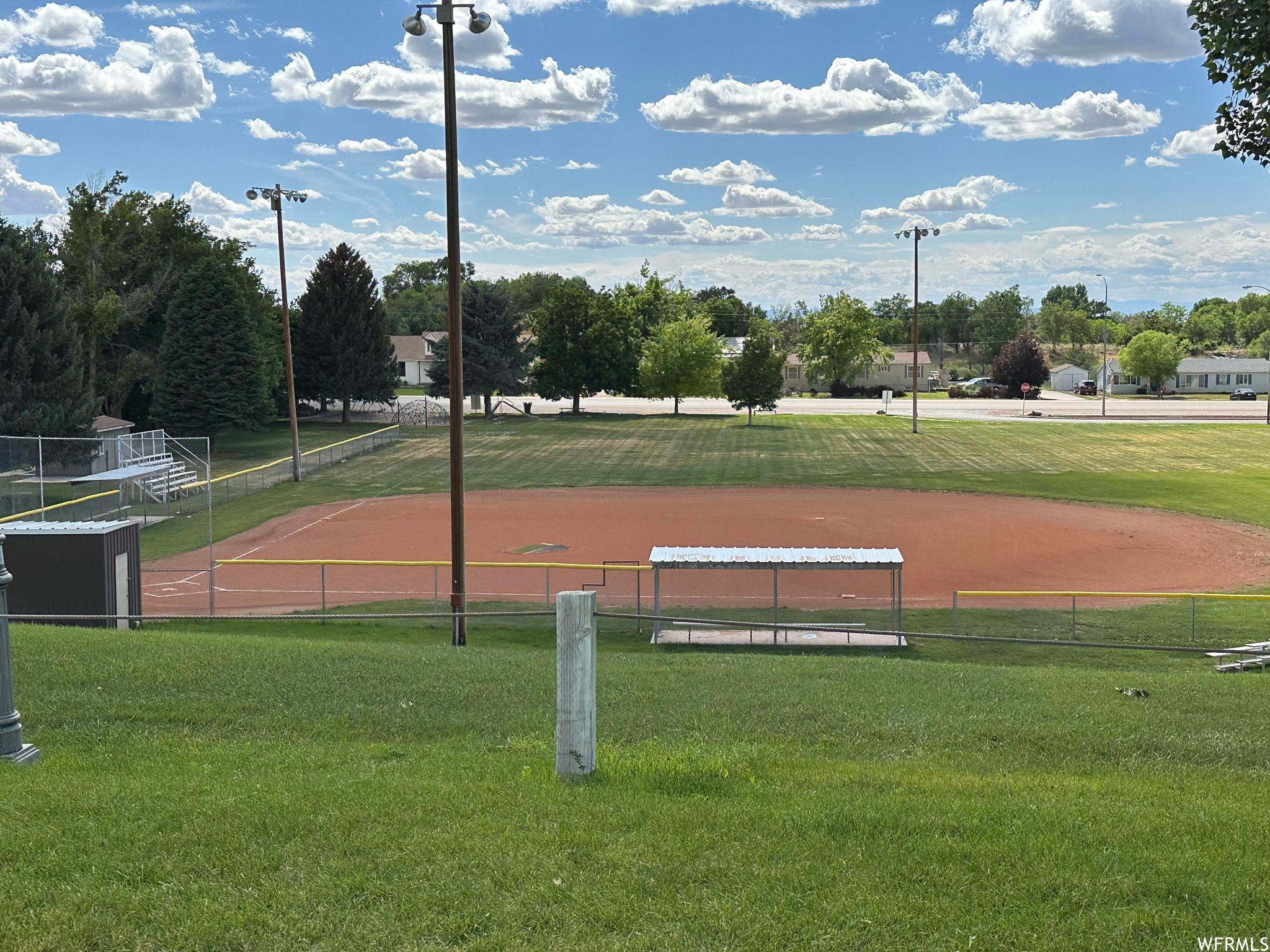 View of property's community with a lawn