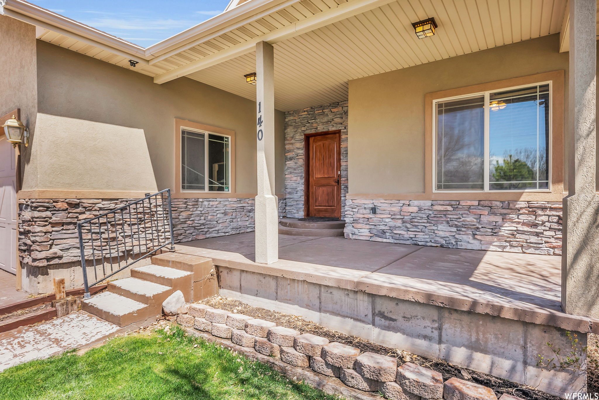 View of exterior entry featuring a yard