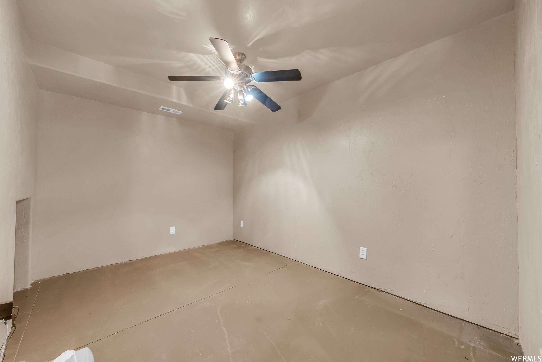 Spare room featuring a ceiling fan