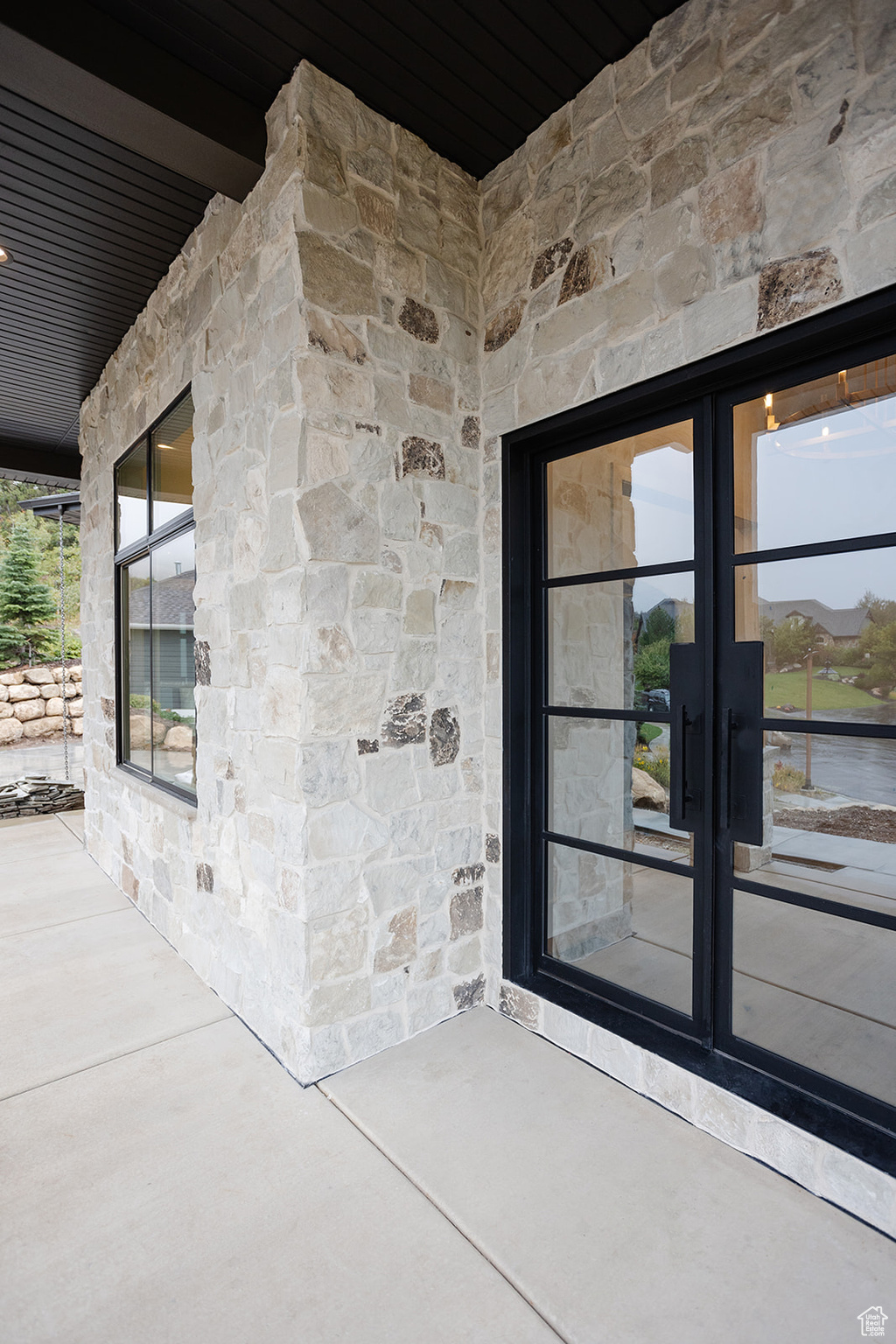 Entrance to home featuring a patio area and french doors