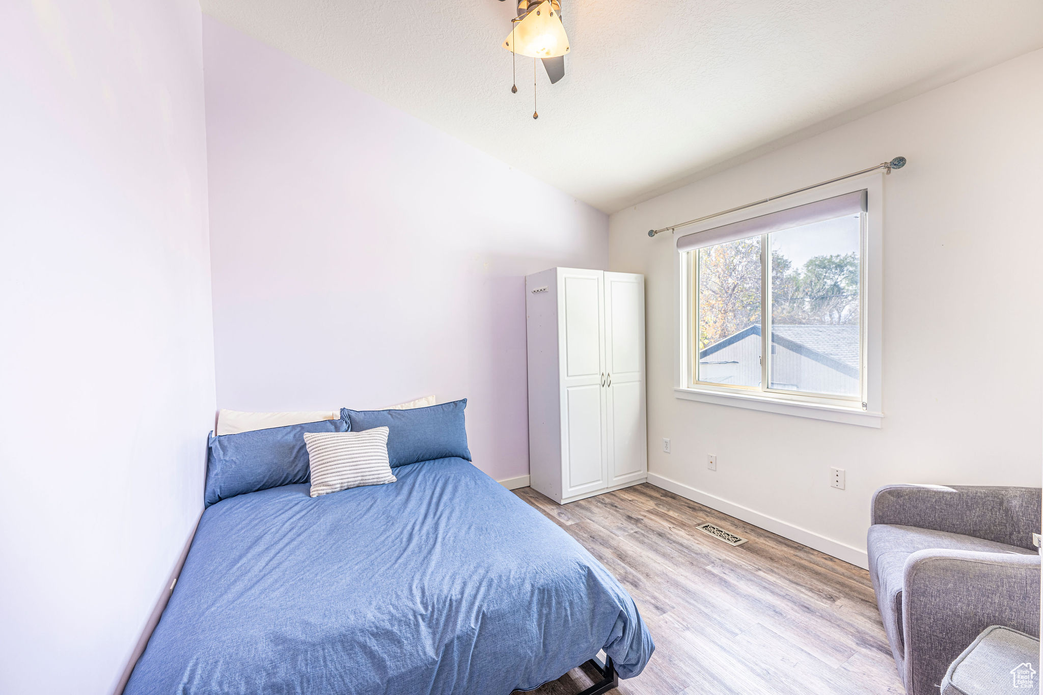 Bedroom featuring light hardwood / wood-style floors, ceiling fan, and lofted ceiling