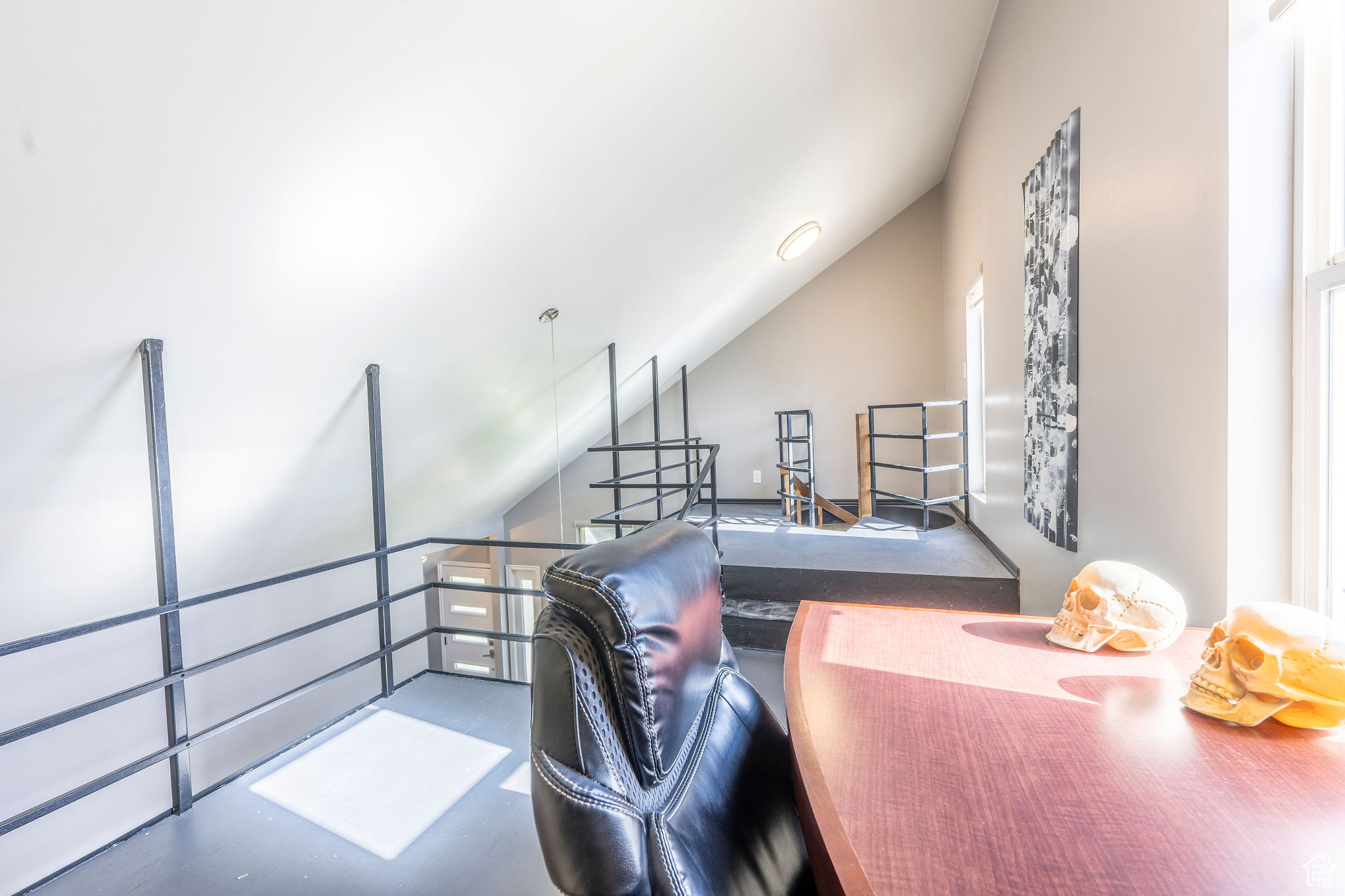 Office area featuring vaulted ceiling