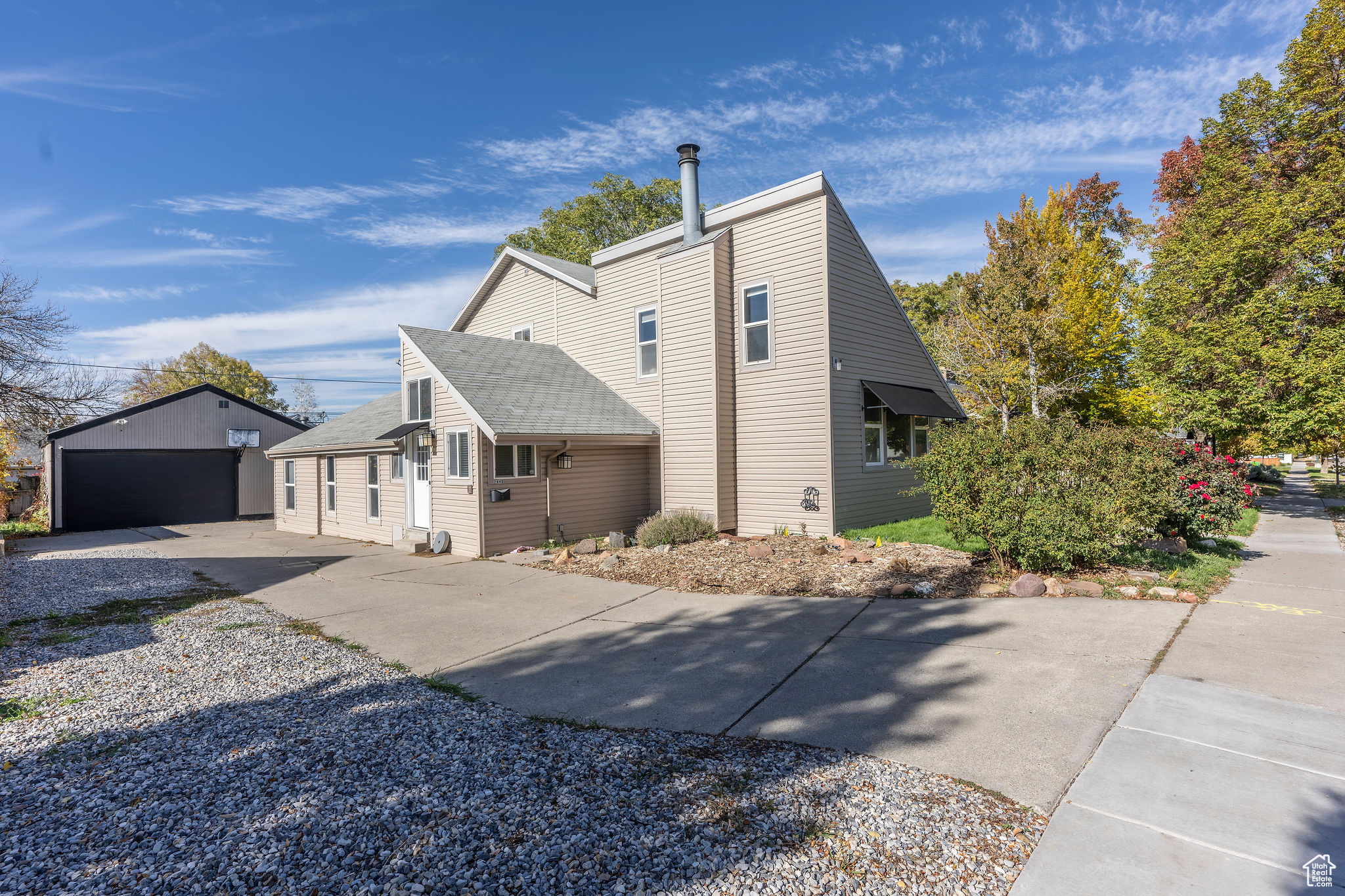 View of property exterior featuring an outbuilding and a garage