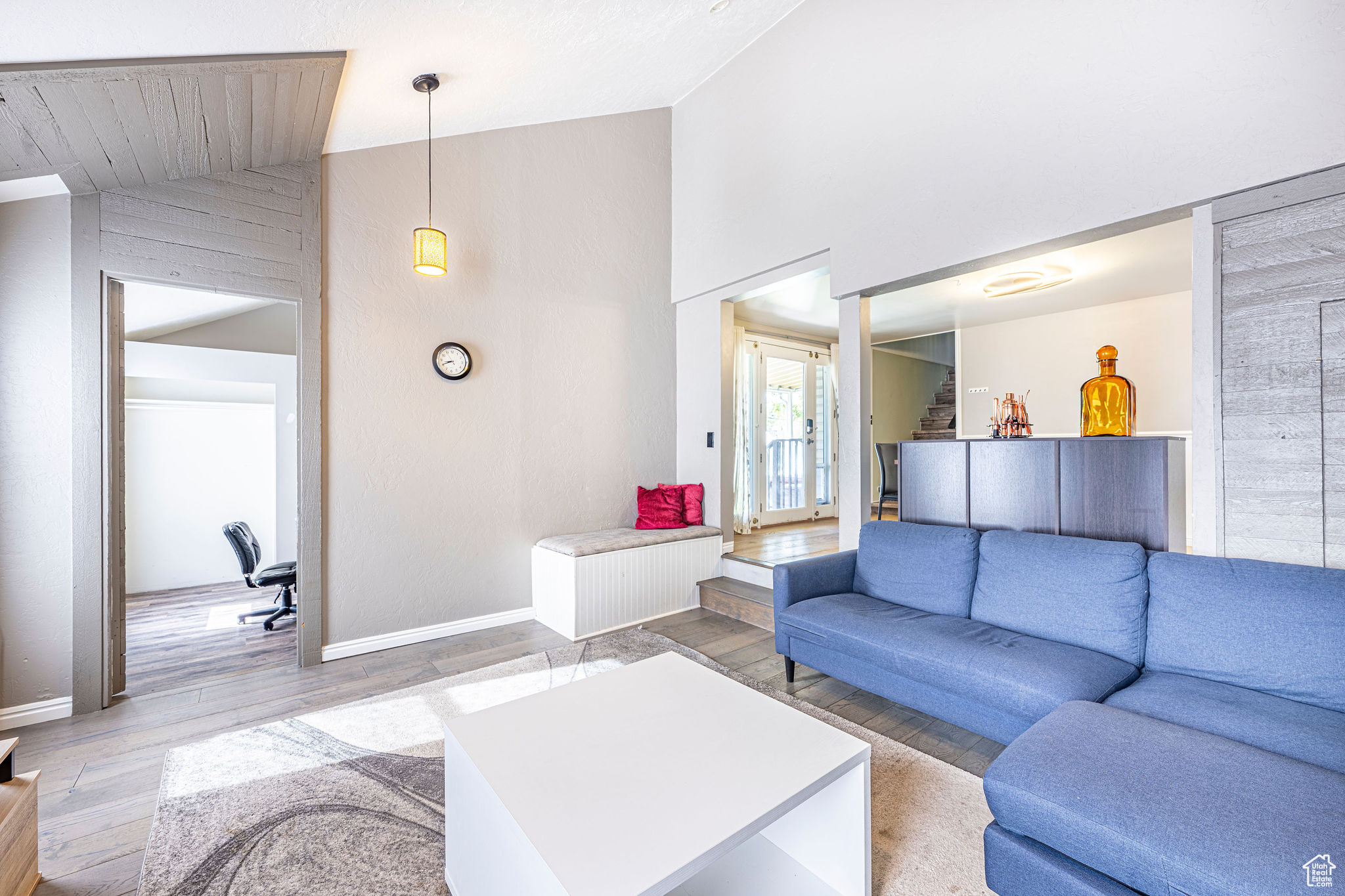 Living room with hardwood / wood-style floors and lofted ceiling