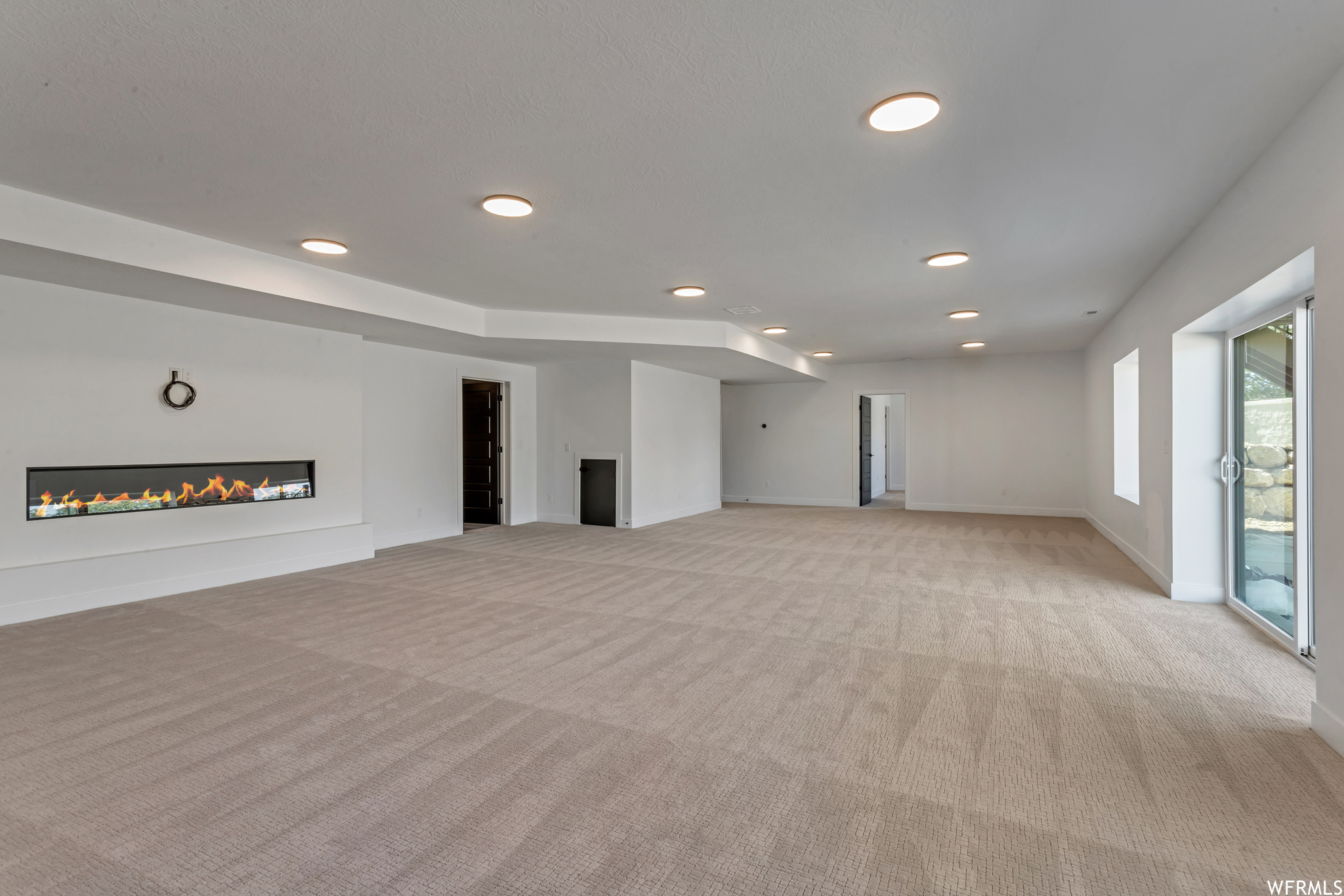Warm carpeting and a fireplace  add to the family room in this home
