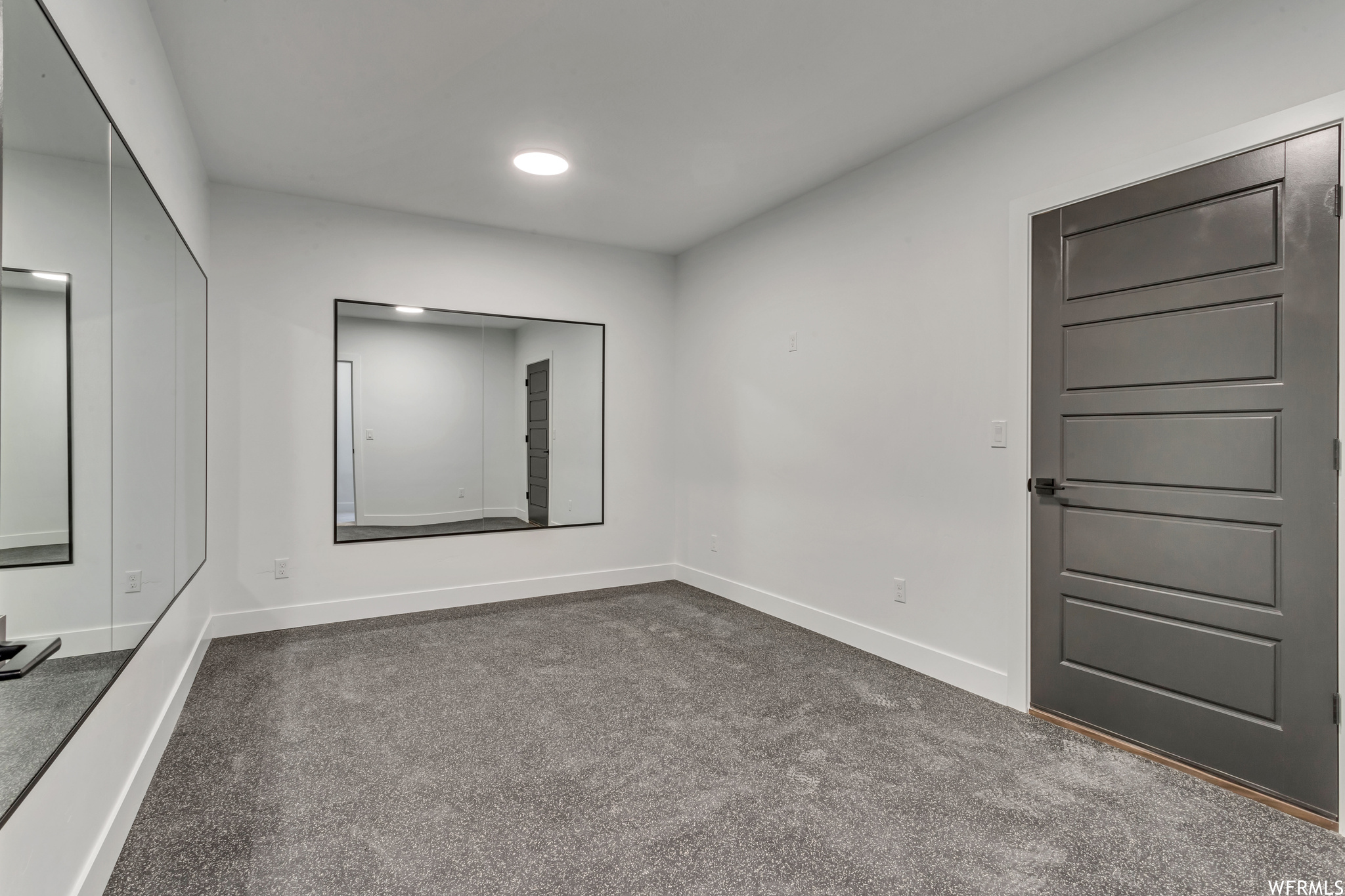 These owners chose to add specialty flooring and mirrors to create a gym room in their basement