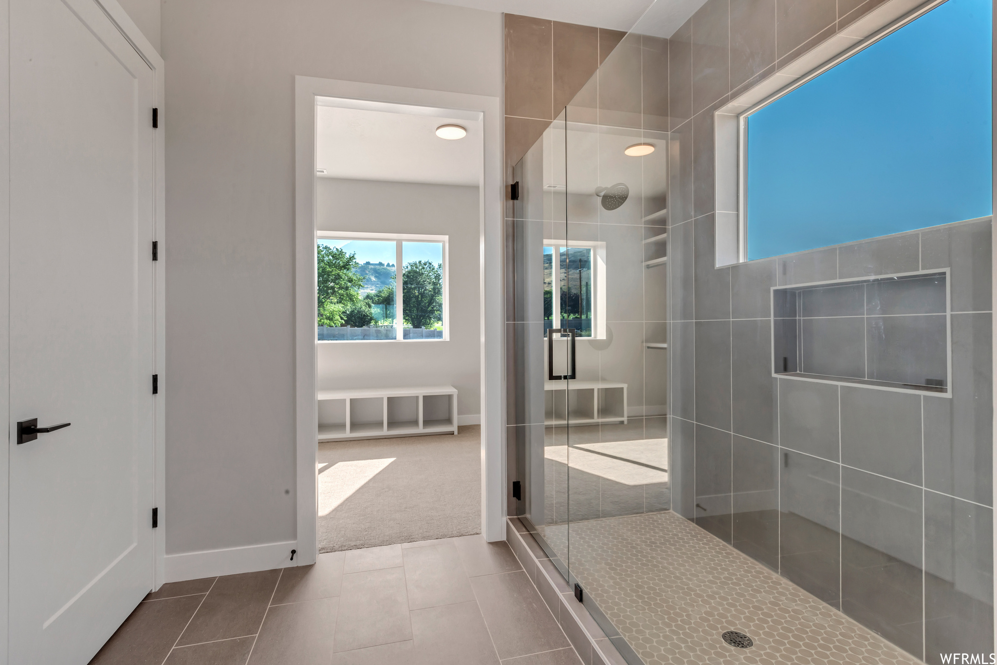 Glass doors enclose the shower area
