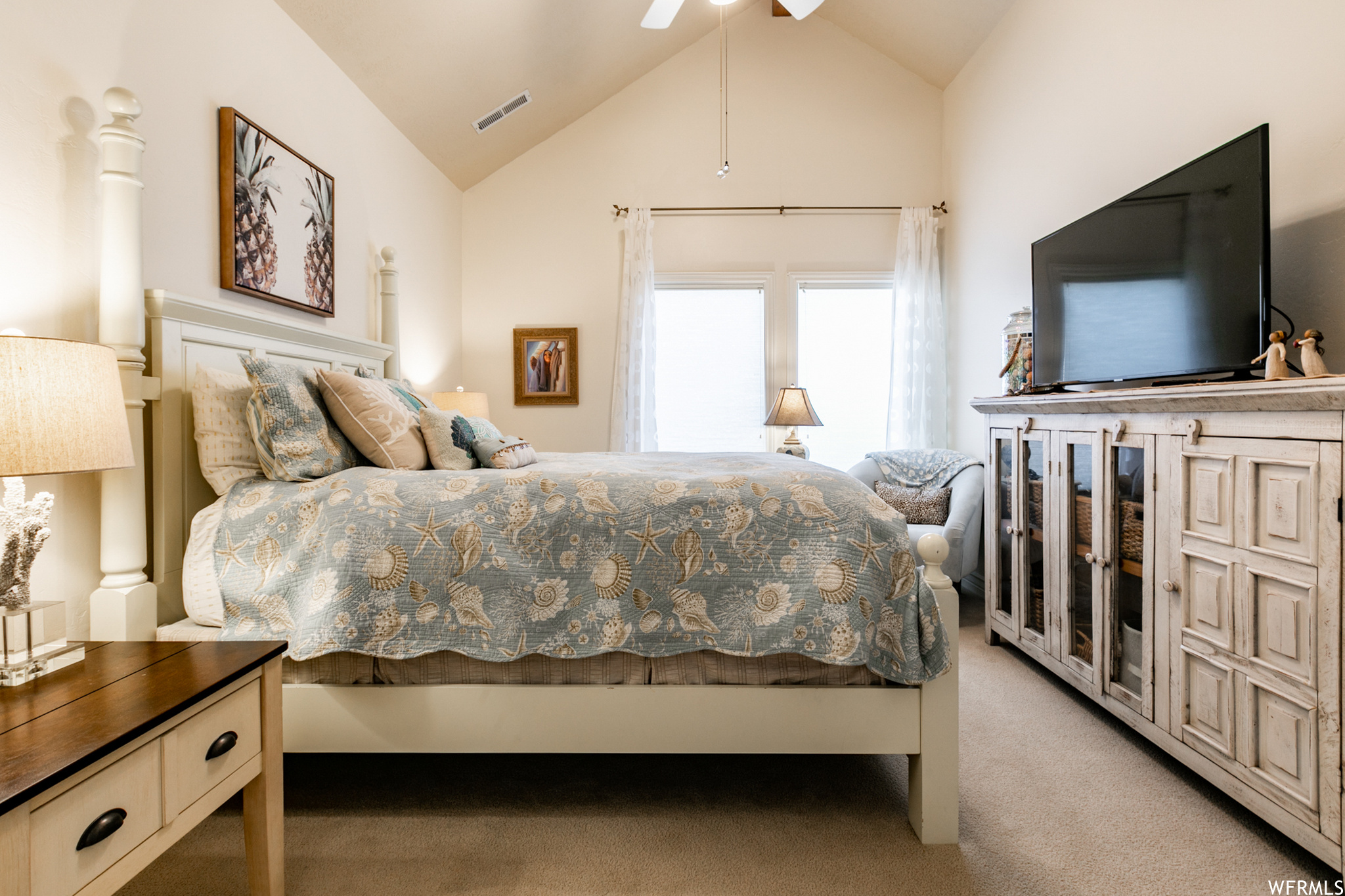 High ceilings, a ceiling fan and a large walk-in closet complete this sunny bedroom.