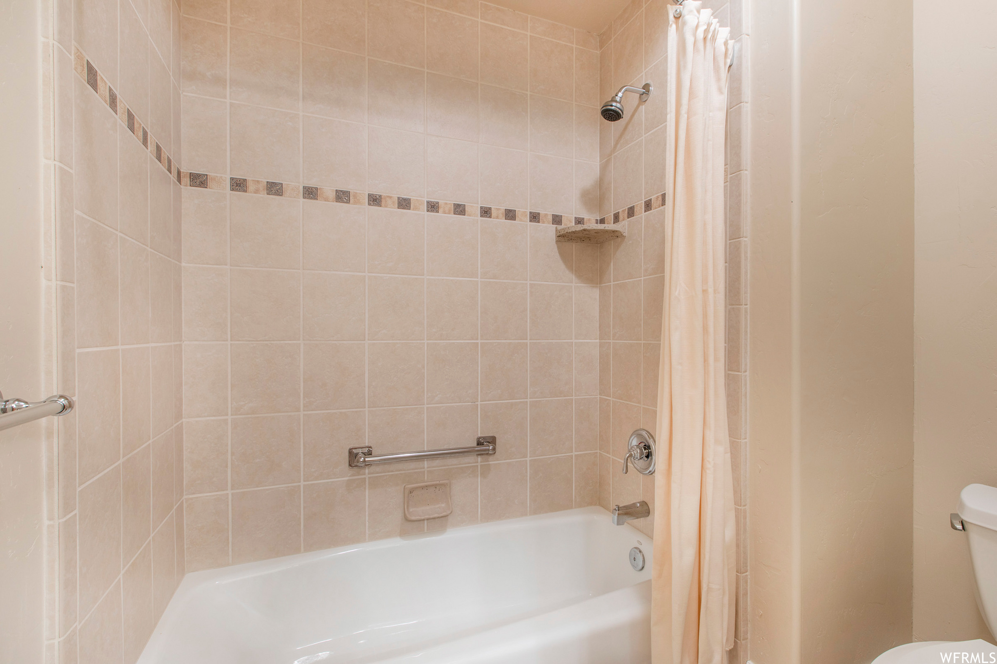 A door separates the tub and toilet from the vanity area of the upstairs bath.
